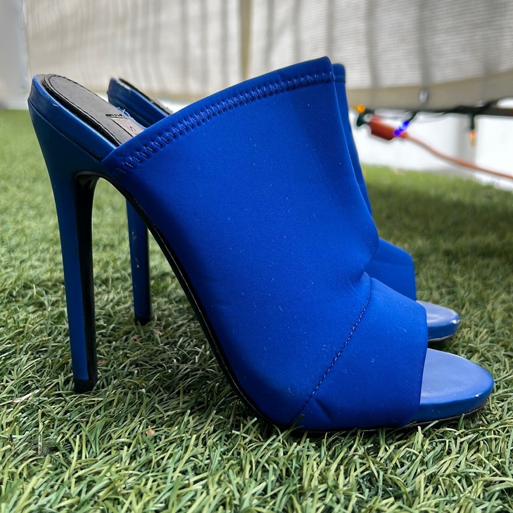 unique blue heels.stretchy material. heels with a few damages on heel and edges
